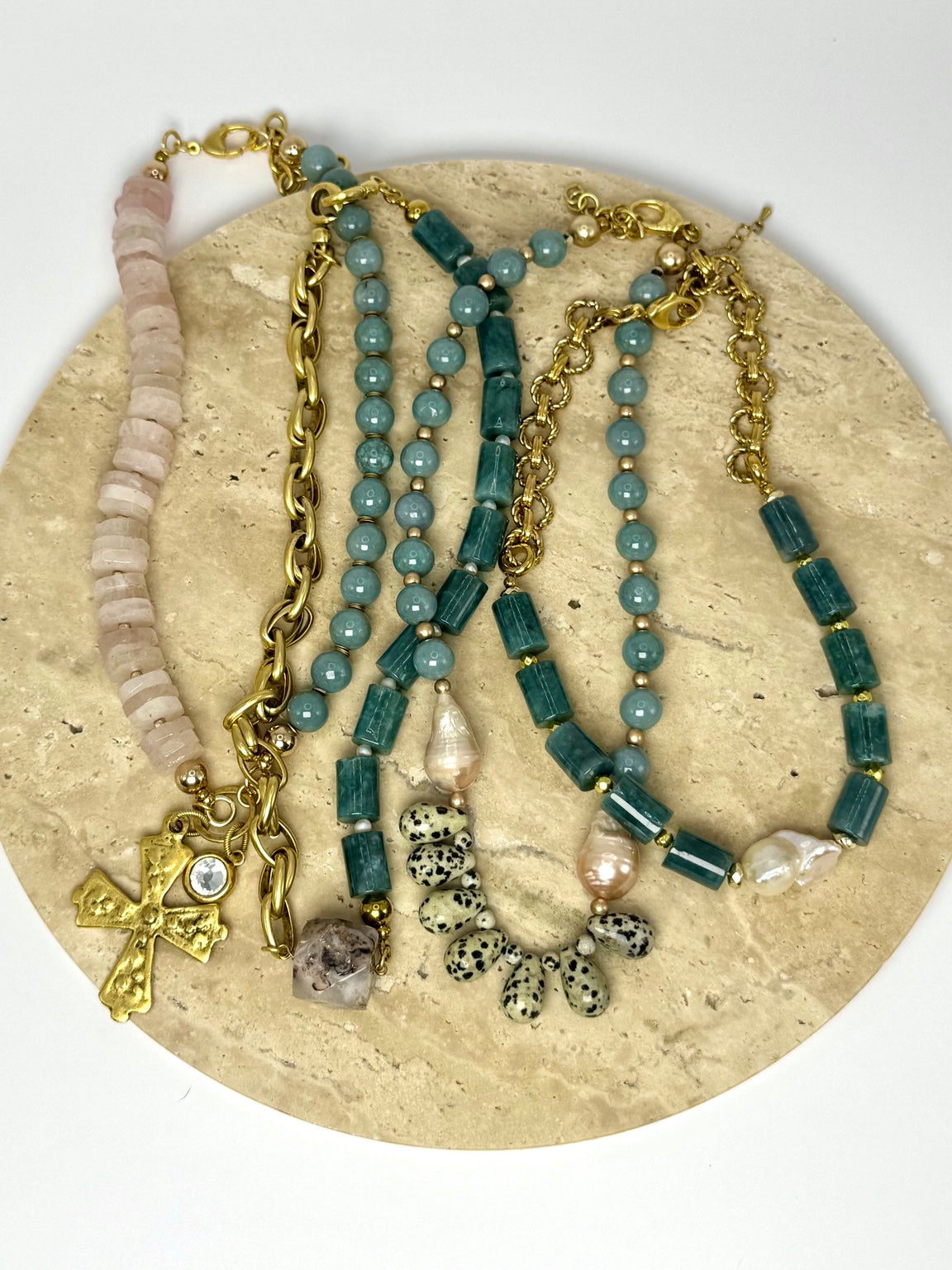 The Bones Collection necklace designs together on a stone tray