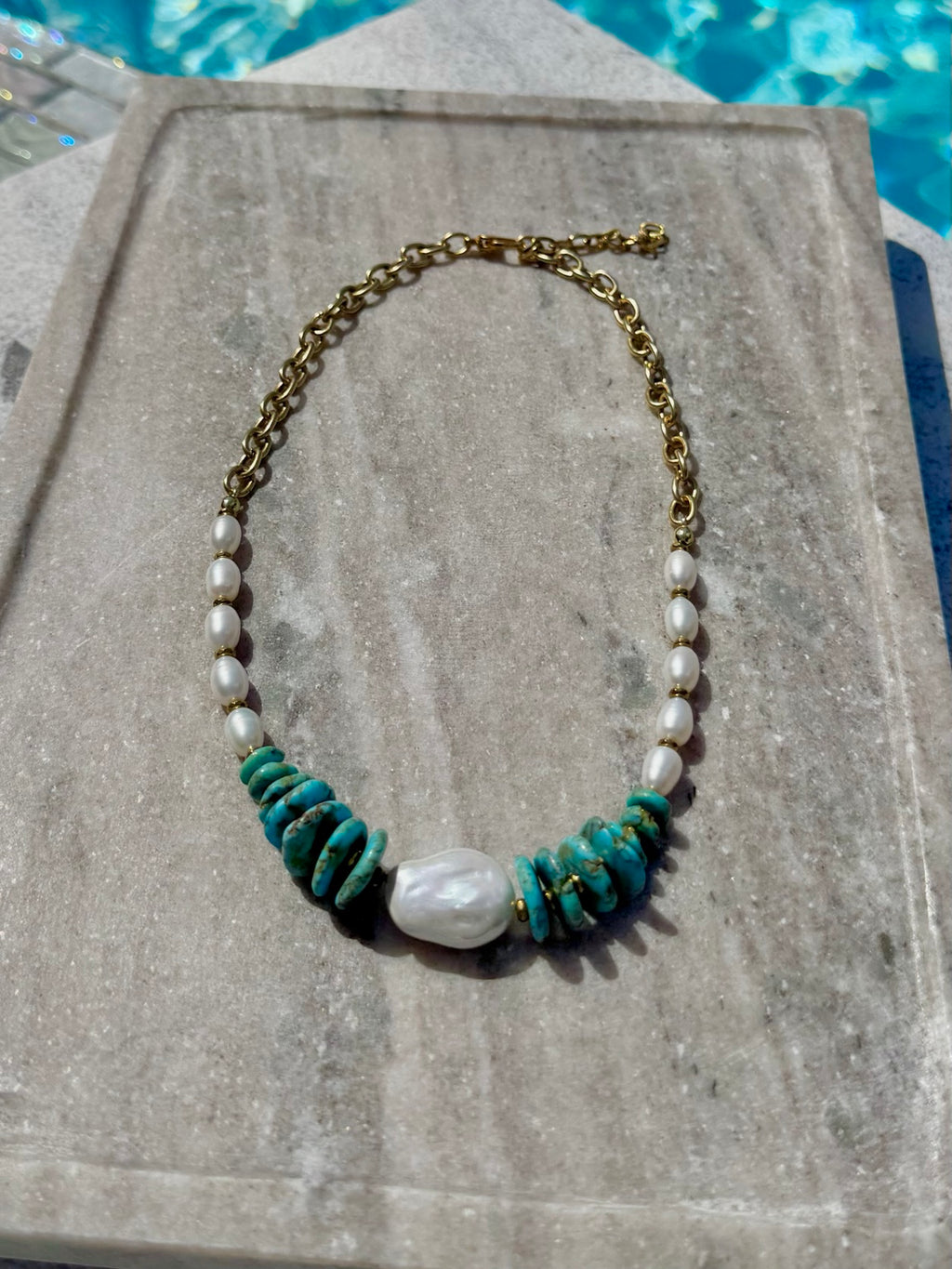 Dyed howlite and freshwater pearl necklace with baroque pearl photographed poolside