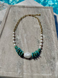 Dyed howlite and freshwater pearl necklace with baroque pearl photographed poolside