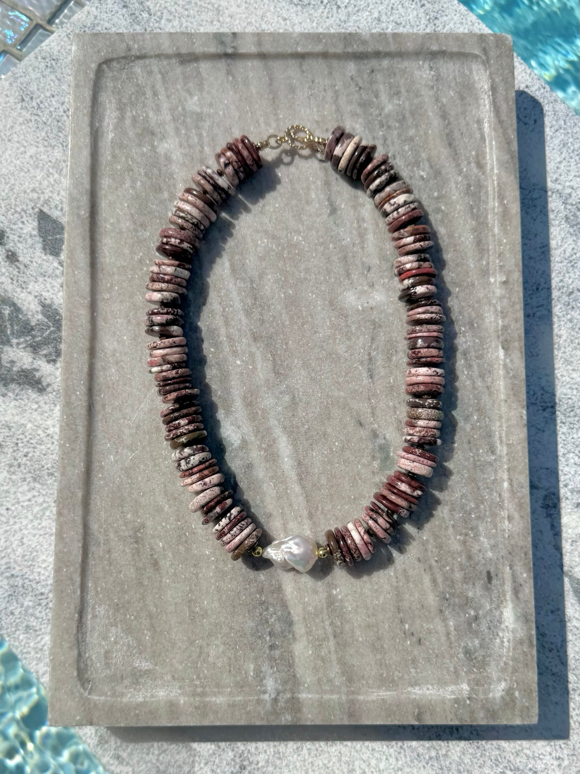 Brown turquoise disc necklace with baroque pearl photographed poolside