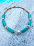 Turquoise barrel and baroque pearl necklace photographed poolside
