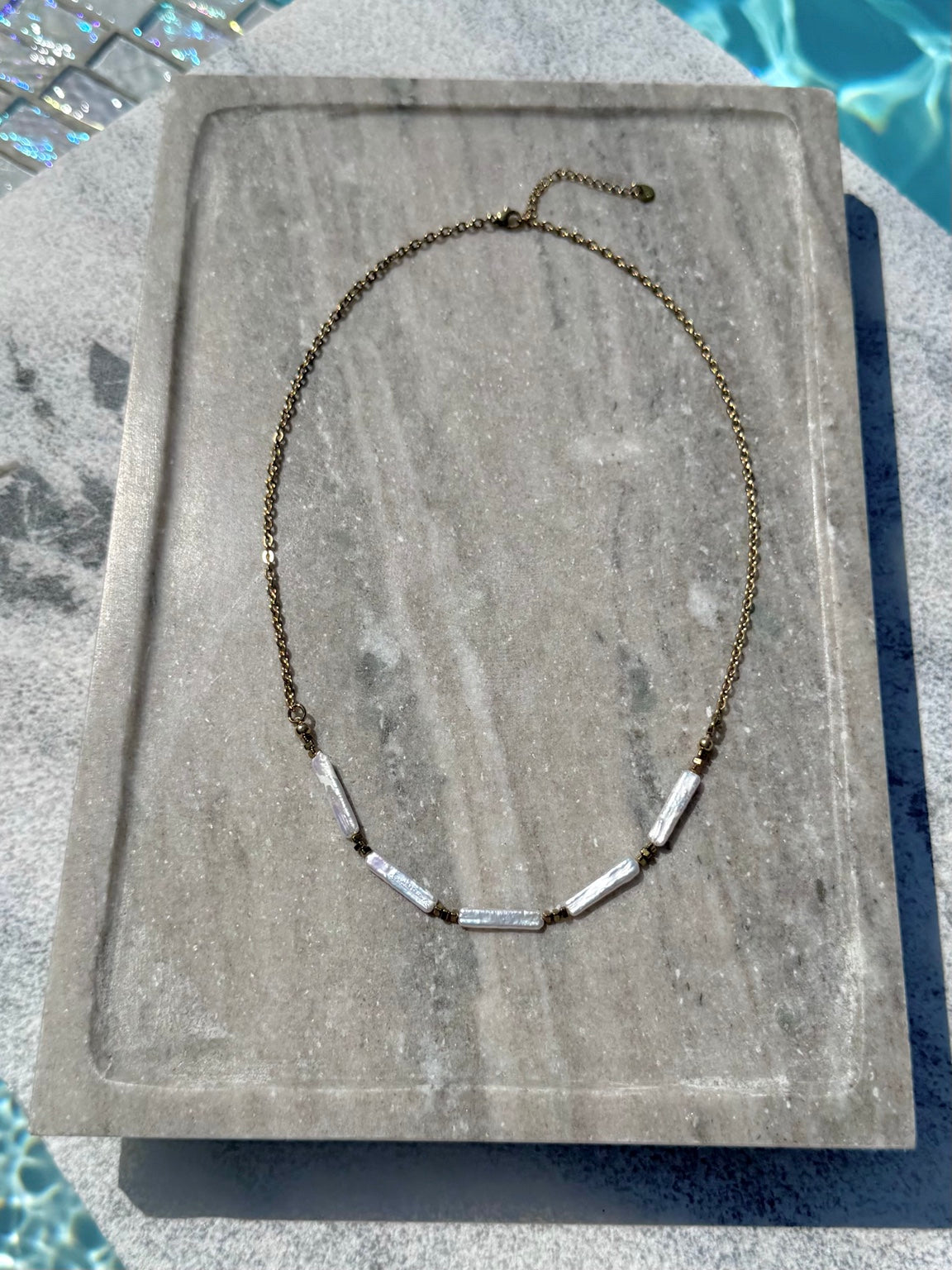 Full view of freshwater stick pearl and gold chain layering necklace