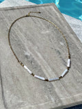 Freshwater stick pearl and gold chain necklace photographed poolside